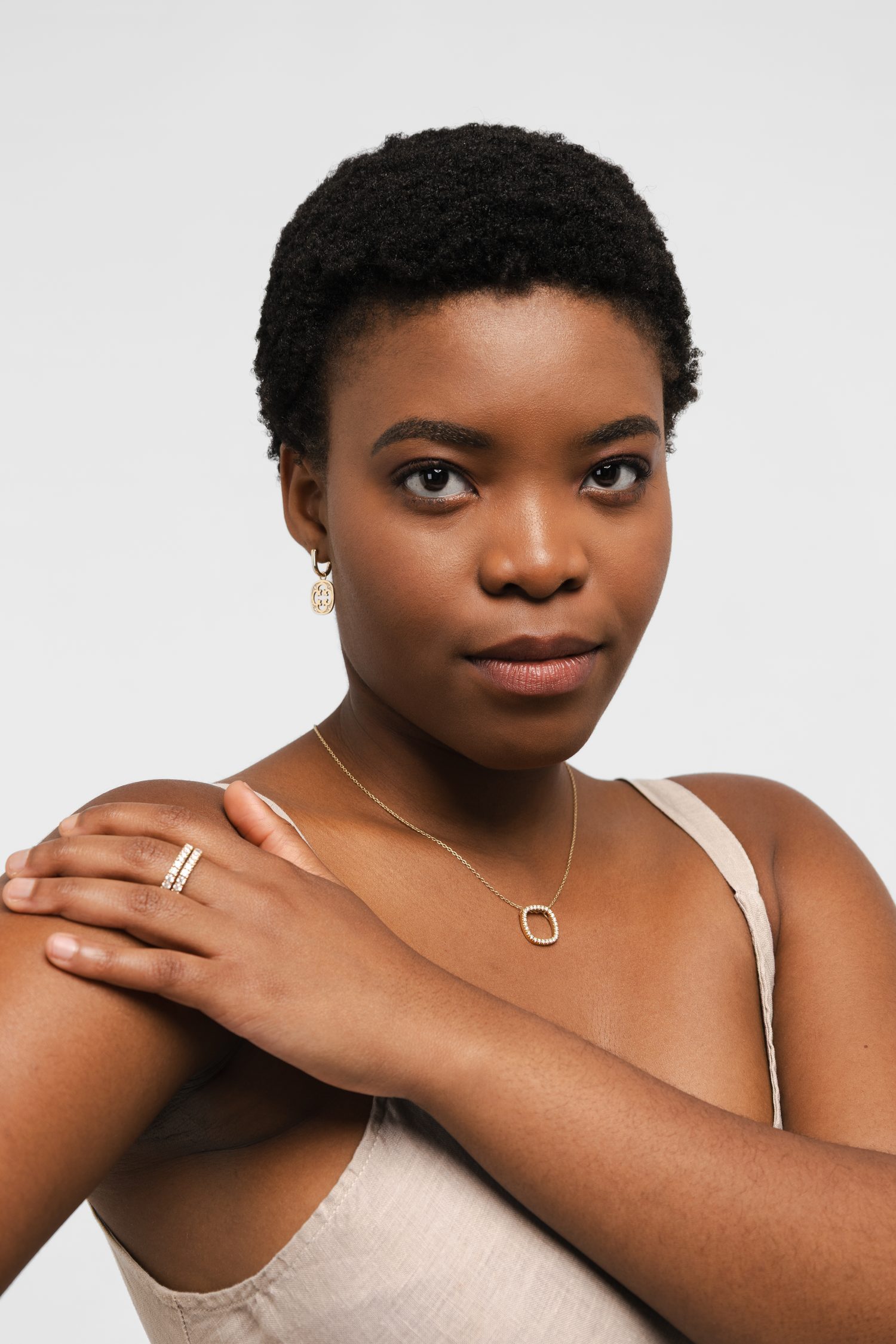 The same open-square pendant, ring and earring photographed in colour