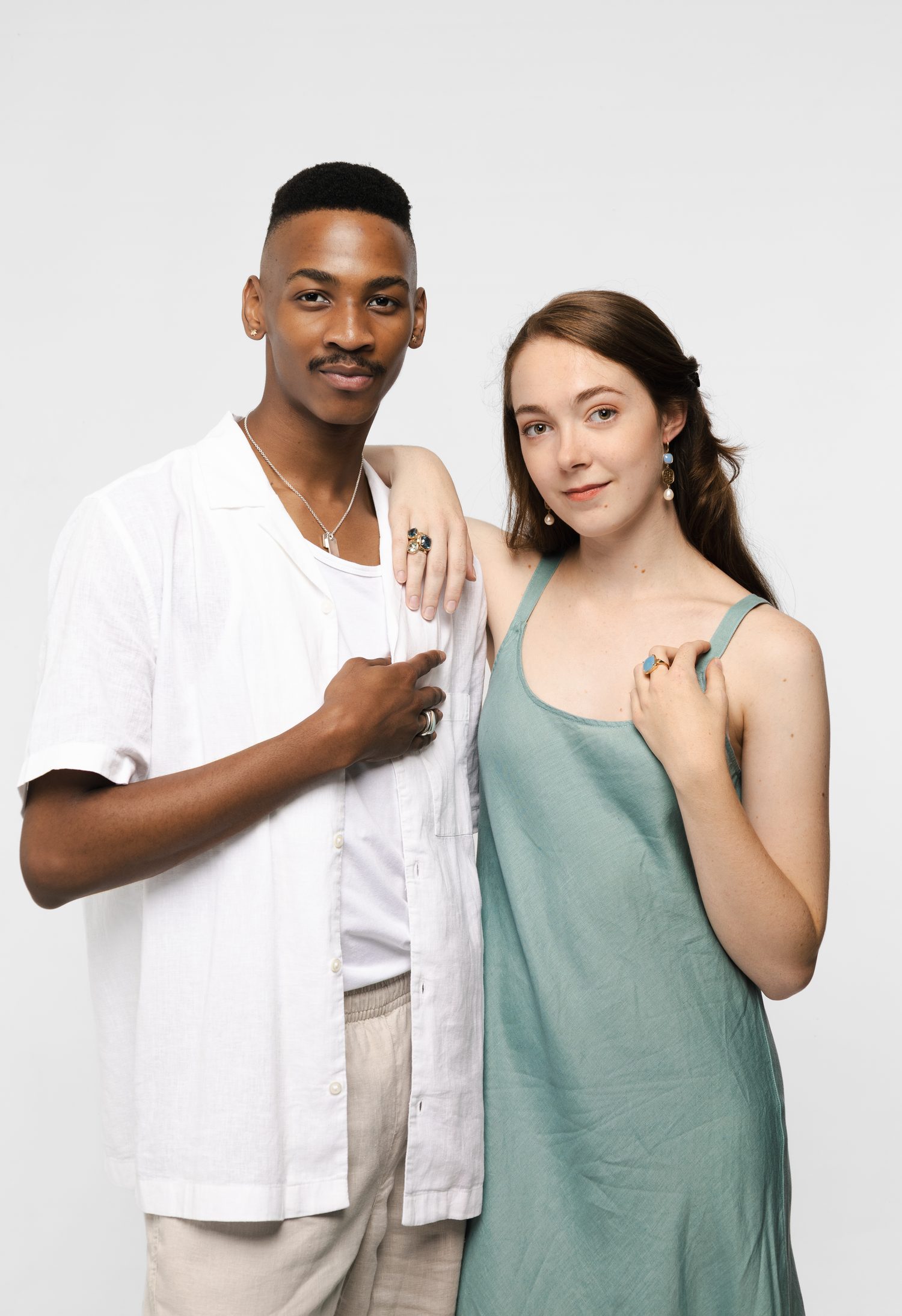 A man and a woman wearing pieces from the same collection